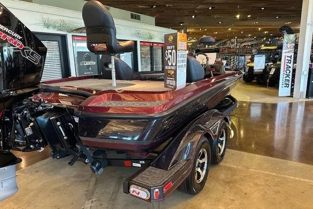 Slide: The Image of 2026 Nitro Z21 XL Pro boat displayed in showroom, featuring sleek design and dual-axle trailer. - 2