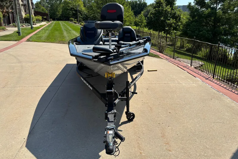 Slide: The Image of 2026 Tracker Pro Team 175 boat on driveway, surrounded by greenery. - 2
