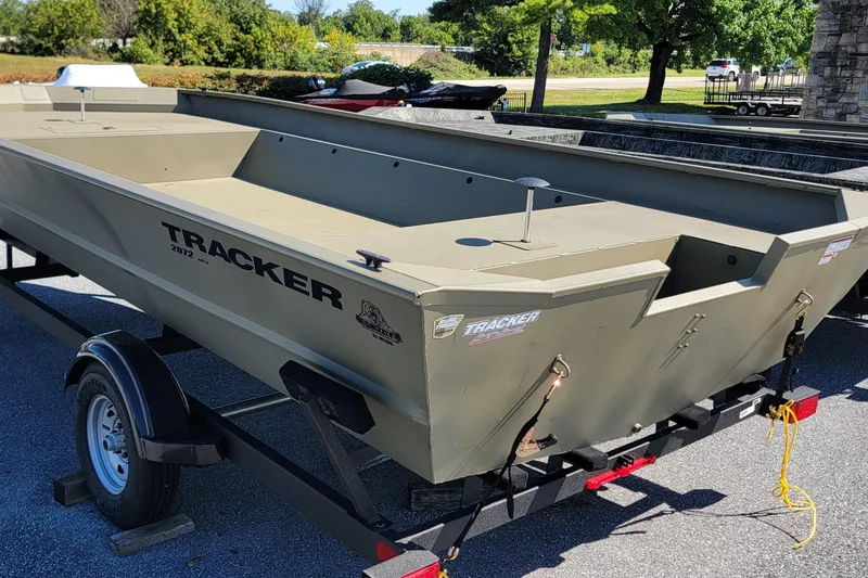 The Image of 2026 Tracker GRIZZLY 2072 Utility boat on trailer, parked outdoors. - 0