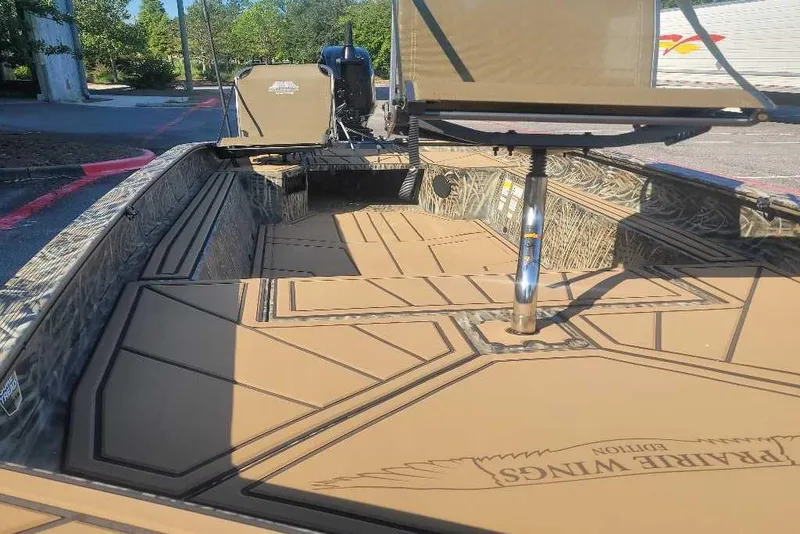 Slide: The Image of 2026 Tracker Grizzly 1650 T Prairie Wings Edition boat interior with camo design. - 2