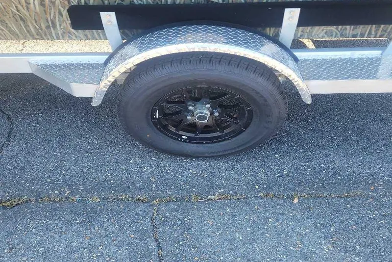 Slide: The Image of Trailer wheel of 2026 Tracker Grizzly 1650 T Prairie Wings Edition on asphalt. - 5