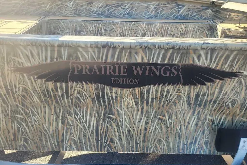 Slide: The Image of 2026 Tracker Grizzly 1650 T Prairie Wings Edition with camouflage design and logo. - 6