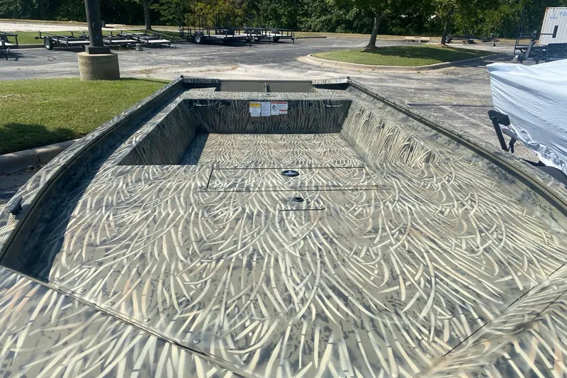 Slide: The Image of 2026 Tracker Grizzly 1754 Utility boat with camouflage interior design. - 2