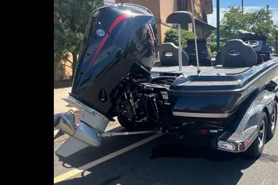 Slide: The Image of 2026 Nitro Z21 XL Pro boat with powerful outboard motor, parked outdoors. - 2