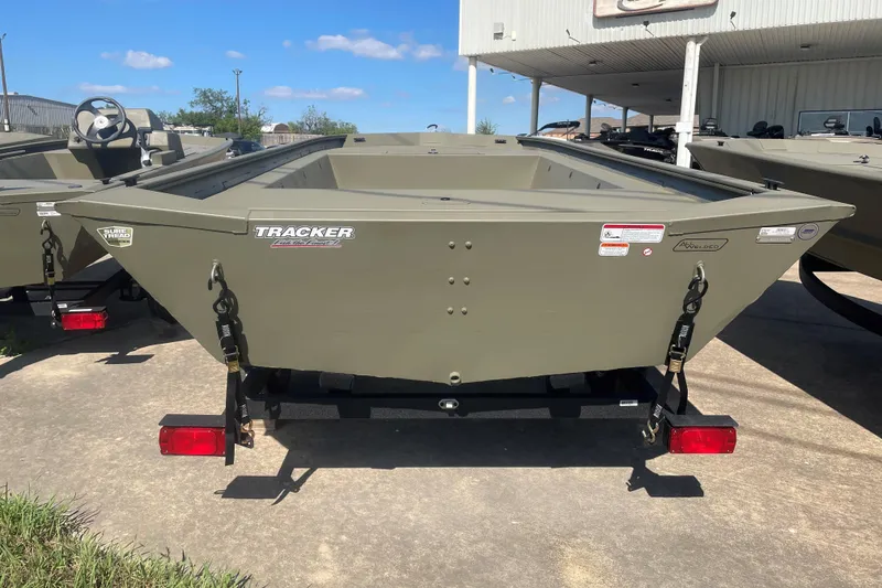 Slide: The Image of 2026 Tracker Grizzly 1754 Utility boat on trailer, displayed outdoors under clear sky. - 3