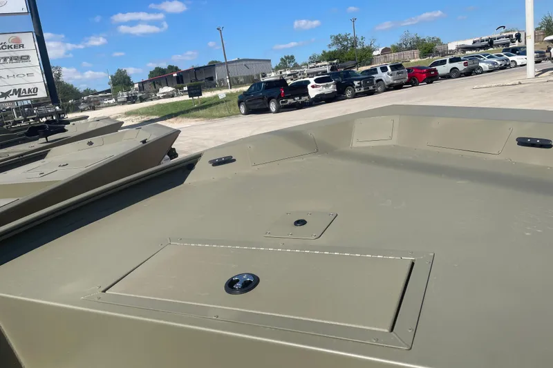 Slide: The Image of 2026 Tracker Grizzly 1754 Utility boat in a dealership lot under a clear blue sky. - 7