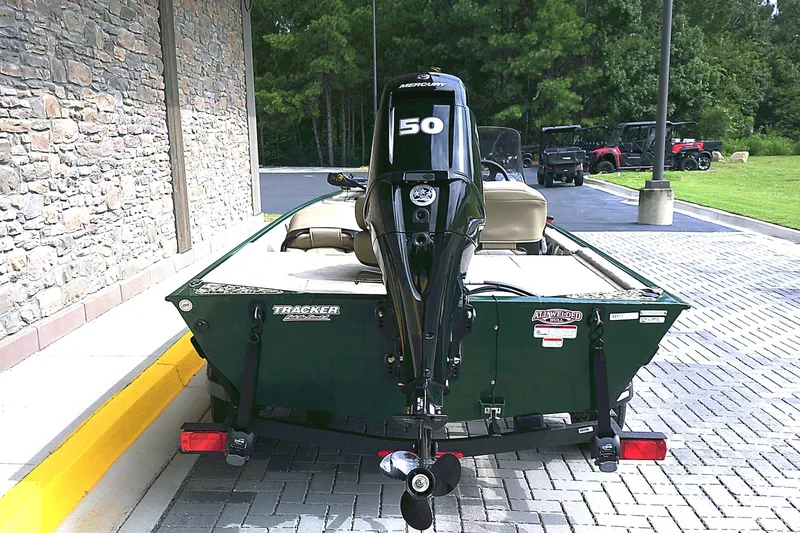 Slide: The Image of 2026 Tracker Bass Tracker Classic Limited boat with Mercury 50 engine, parked outdoors. - 3