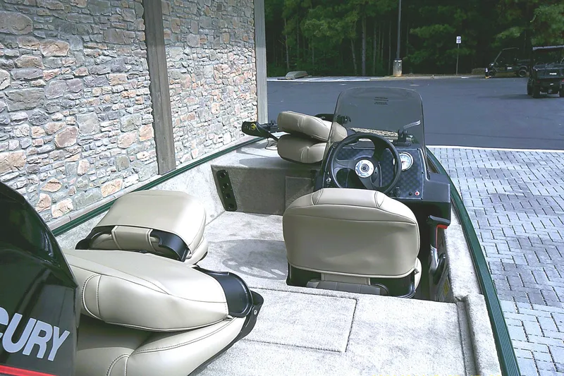 Slide: The Image of 2026 Tracker Bass Tracker Classic Limited boat interior with beige seats and steering console. - 4