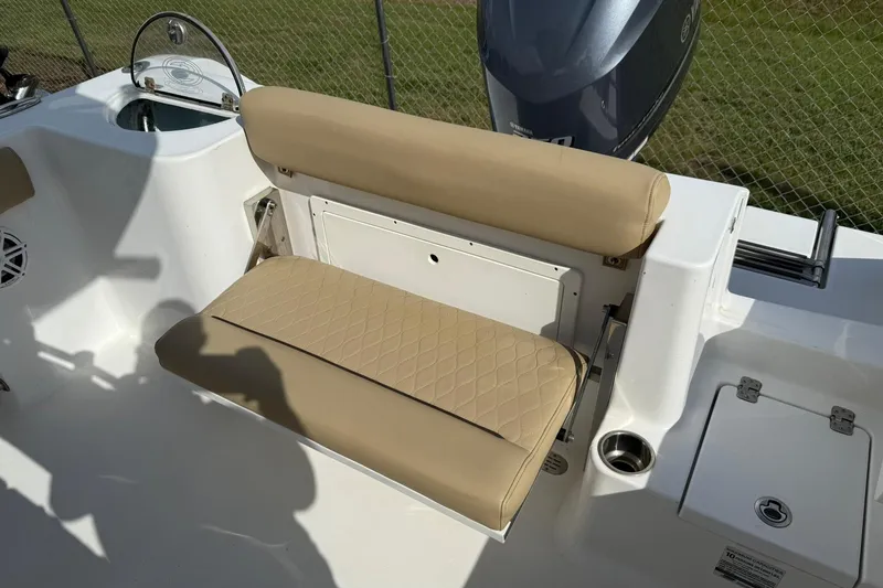 Slide: The Image of 2018 Sportsman Open 232 Center Console boat with tan seating and Yamaha engine. - 10