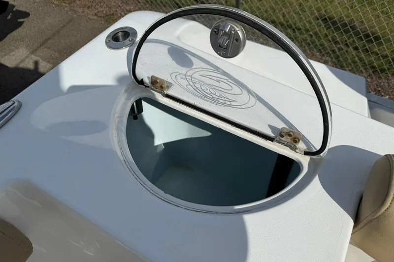 Slide: The Image of 2018 Sportsman Open 232 Center Console livewell with open lid, showcasing interior. - 11