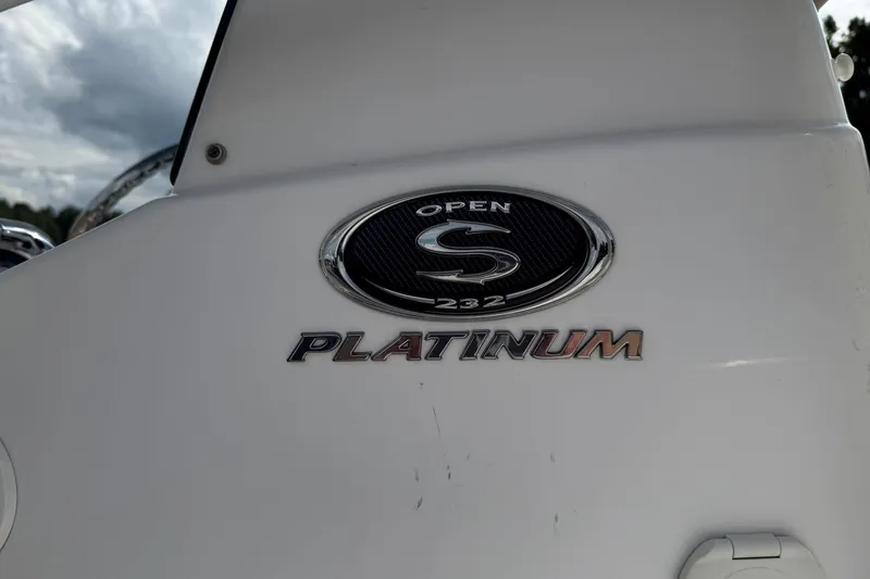 Slide: The Image of 2018 Sportsman Open 232 Center Console boat emblem with "Platinum" badge. - 13