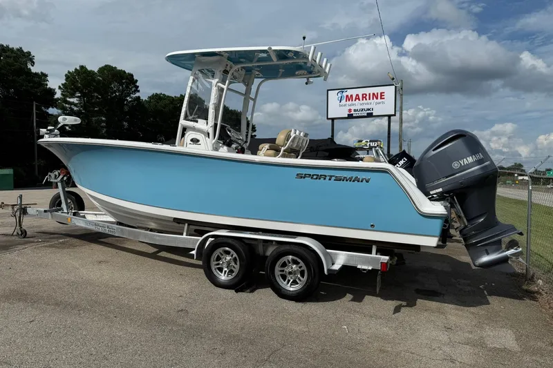 Slide: The Image of 2018 Sportsman Open 232 Center Console boat on trailer, parked outdoors. - 2