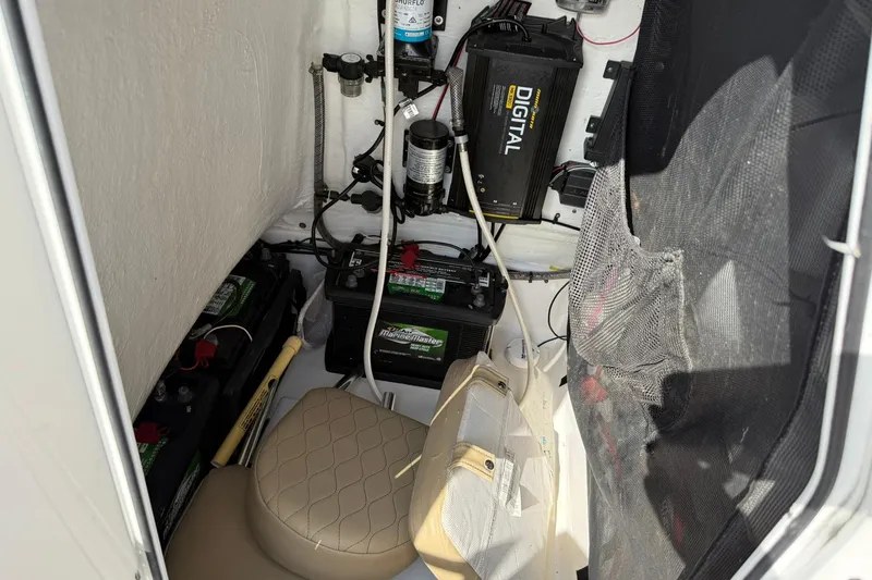 Slide: The Image of Interior of a 2018 Sportsman Open 232 Center Console boat showing batteries and equipment. - 7