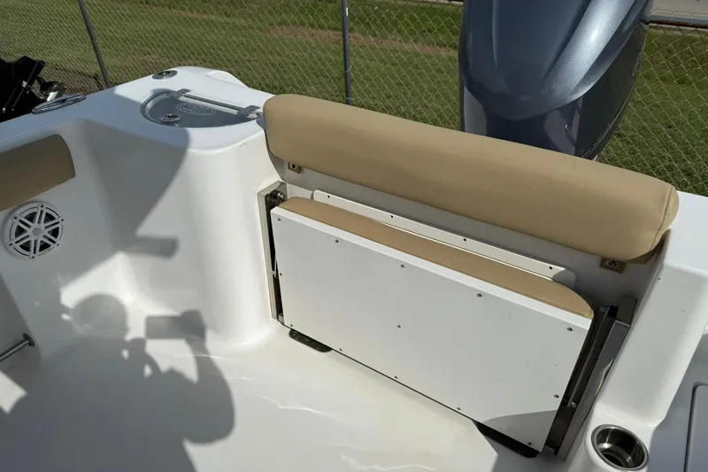 Slide: The Image of 2018 Sportsman Open 232 Center Console boat with beige seating and speaker detail. - 9