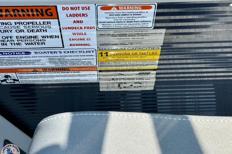 Slide: The Image of 2024 Bennington 22 LSB warning labels and capacity information on boat interior. - 11