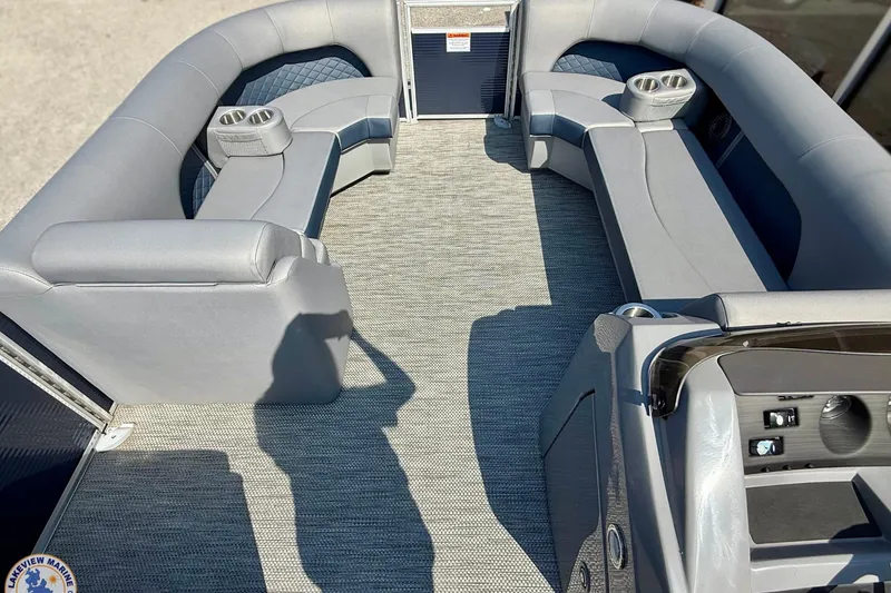 Slide: The Image of 2024 Bennington 22 LSB pontoon boat interior with gray seating and cup holders. - 3