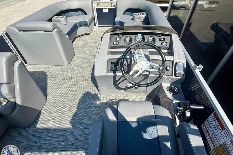 Slide: The Image of 2024 Bennington 22 LSB boat interior with steering wheel and seating arrangement. - 5