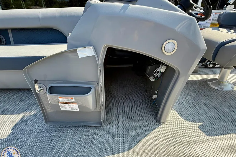 Slide: The Image of 2024 Bennington 22 LSB boat interior storage compartment with open door. - 7