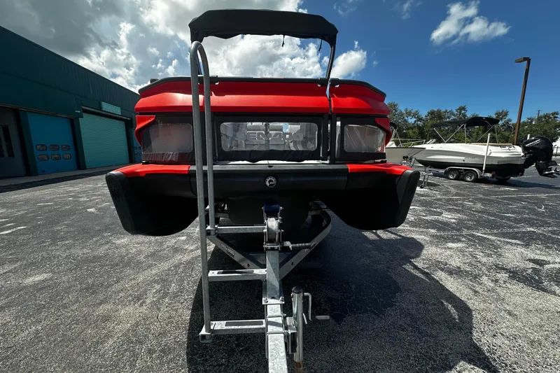Slide: The Image of 2023 Sea-Doo Switch 16 on trailer, rear view, parked outdoors under blue sky. - 3
