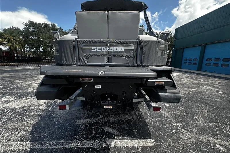 Slide: The Image of 2023 Sea-Doo Switch 16 rear view, parked on asphalt, showcasing sleek design. - 4