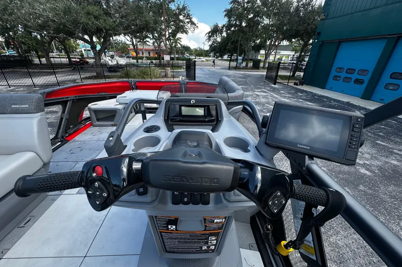 Slide: The Image of 2023 Sea-Doo Switch 16 dashboard with steering wheel and Garmin navigation system. - 7