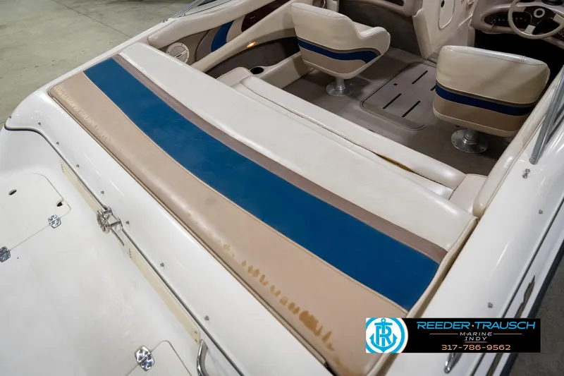 Slide: The Image of Interior of a 2000 Bryant 196 Limited boat with beige and blue seating. - 12