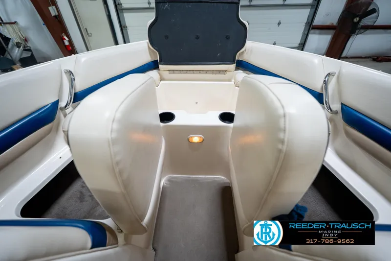 Slide: The Image of Interior of a 2000 Bryant 196 Limited boat with white and blue seating. - 20