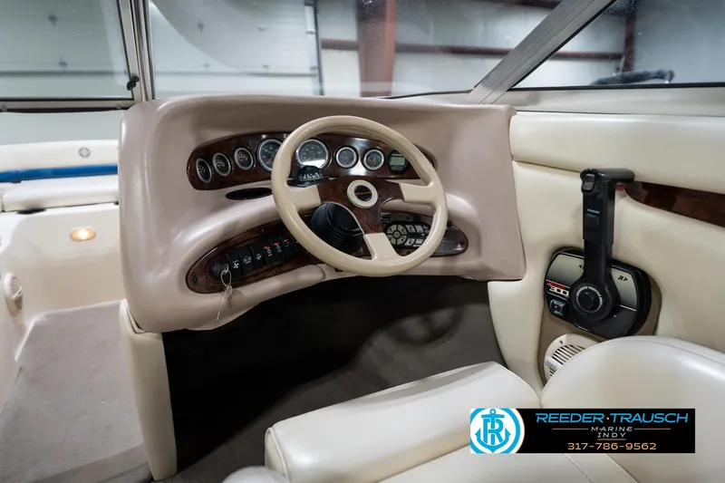 Slide: The Image of Interior view of a 2000 Bryant 196 Limited boat dashboard with steering wheel and controls. - 26