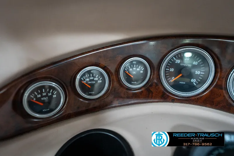 Slide: The Image of Dashboard gauges of a 2000 Bryant 196 Limited boat, featuring volt, water, oil, and RPM indicators. - 28