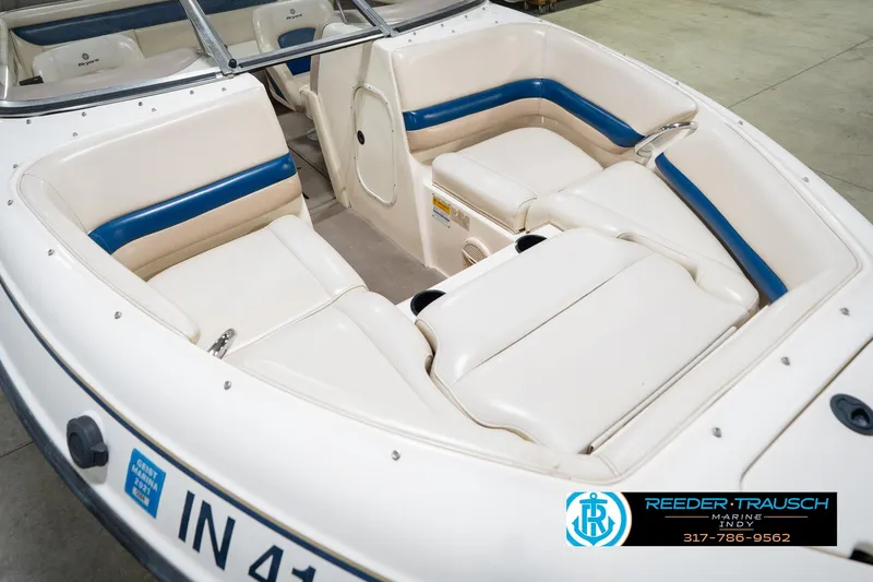 Slide: The Image of Interior of a 2000 Bryant 196 Limited boat with white and blue seating. - 11