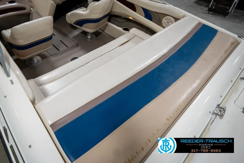 Slide: The Image of Interior of a 2000 Bryant 196 Limited boat with beige and blue seating. - 13