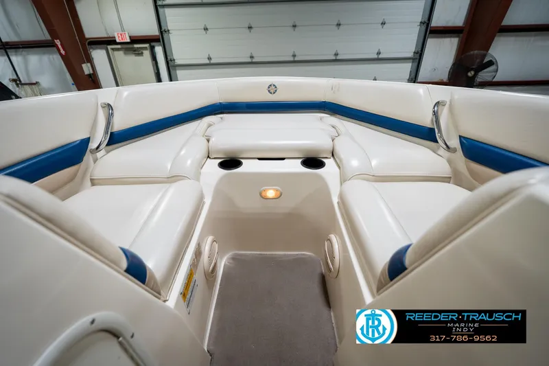 Slide: The Image of Interior of a 2000 Bryant 196 Limited boat with white and blue seating. - 19