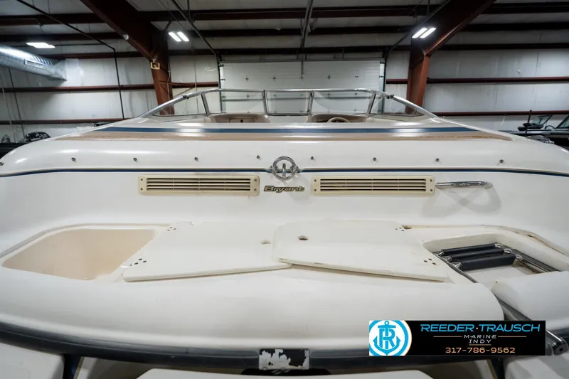 Slide: The Image of Rear view of a 2000 Bryant 196 Limited boat in a warehouse setting. - 24