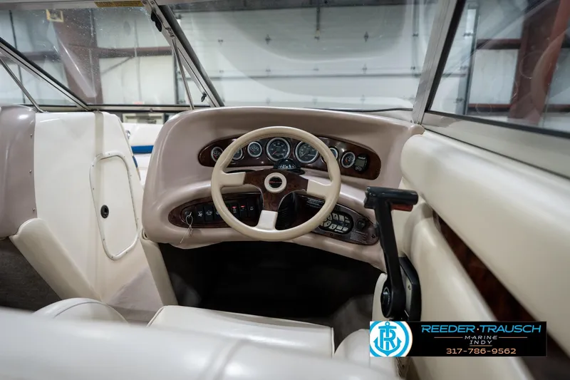 Slide: The Image of Interior view of a 2000 Bryant 196 Limited boat dashboard with steering wheel and controls. - 25