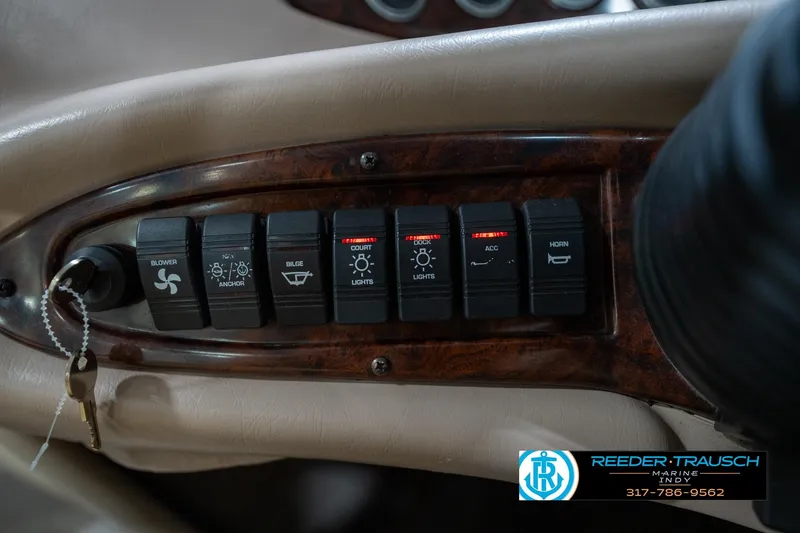 Slide: The Image of Control panel of a 2000 Bryant 196 Limited boat with various switches and key. - 27