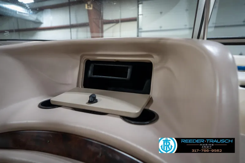 Slide: The Image of Dashboard compartment of a 2000 Bryant 196 Limited boat in a showroom. - 35