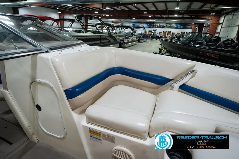 Slide: The Image of Interior of a 2000 Bryant 196 Limited boat with white and blue seating. - 42