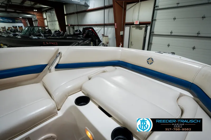 Slide: The Image of Interior of a 2000 Bryant 196 Limited boat with white and blue seating. - 43