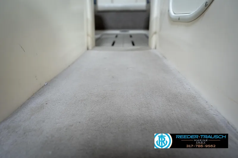 Slide: The Image of Interior view of a 2000 Bryant 196 Limited boat, featuring carpeted flooring. - 44