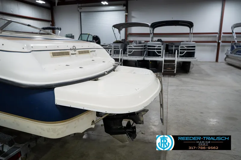 Slide: The Image of 2000 Bryant 196 Limited boat in showroom, rear view with swim platform. - 45