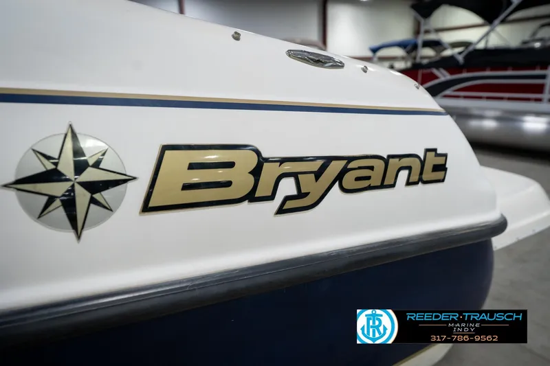 Slide: The Image of Close-up of 2000 Bryant 196 Limited boat logo in showroom setting. - 49