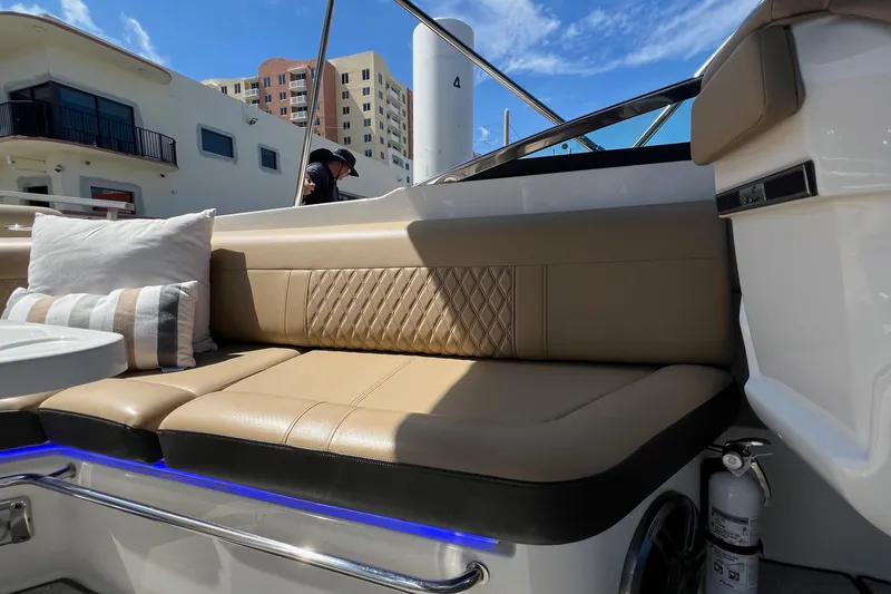 Slide: The Image of Luxurious seating on 2020 Sea Ray 280 SLX boat with cushions and blue LED lighting. - 11