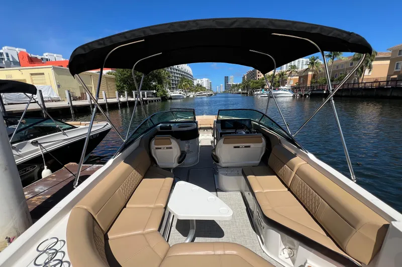 Slide: The Image of 2020 Sea Ray 280 SLX boat with spacious seating, docked in a scenic canal. - 16
