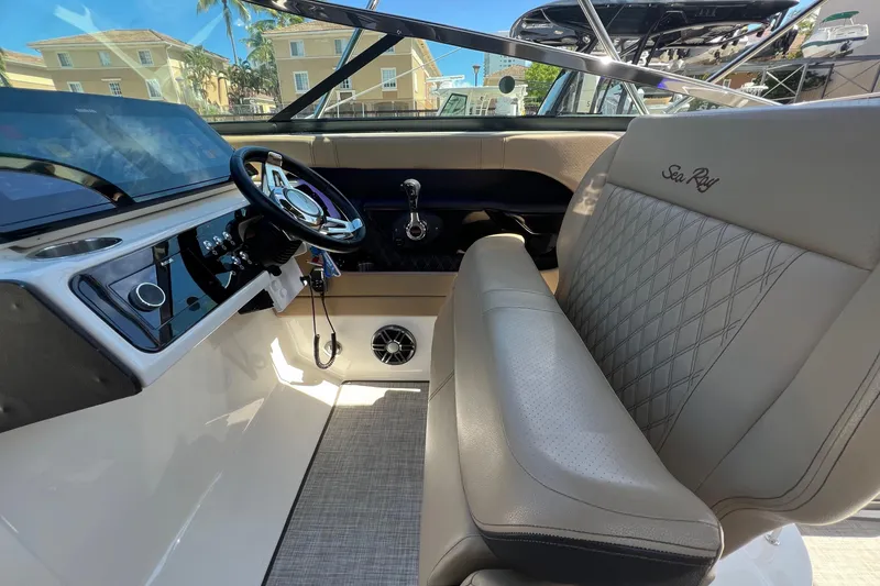 Slide: The Image of 2020 Sea Ray 280 SLX boat interior with steering wheel and luxurious seating. - 19