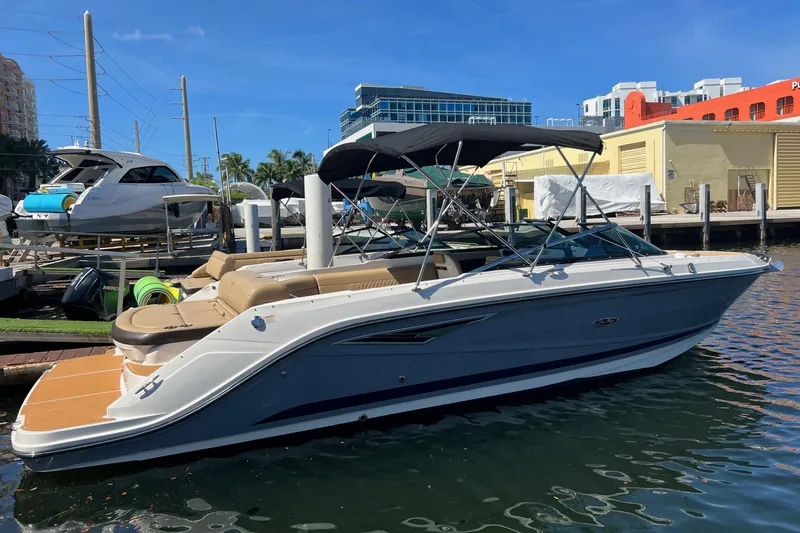 Slide: The Image of 2020 Sea Ray 280 SLX boat docked at marina under clear blue sky. - 2