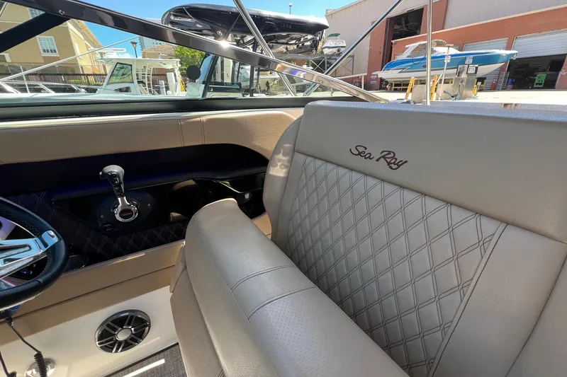 Slide: The Image of Interior of 2020 Sea Ray 280 SLX boat with luxurious seating and steering controls. - 20