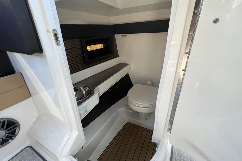Slide: The Image of 2020 Sea Ray 280 SLX boat interior with compact bathroom and modern amenities. - 29