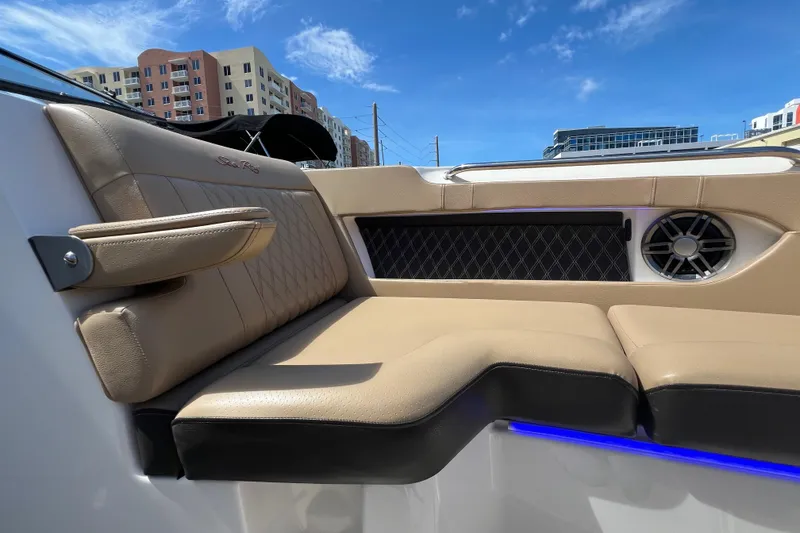 Slide: The Image of Luxurious seating on a 2020 Sea Ray 280 SLX boat, with urban skyline backdrop. - 33