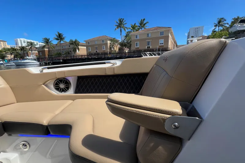 Slide: The Image of Luxurious seating on a 2020 Sea Ray 280 SLX boat, with waterfront view and palm trees. - 35