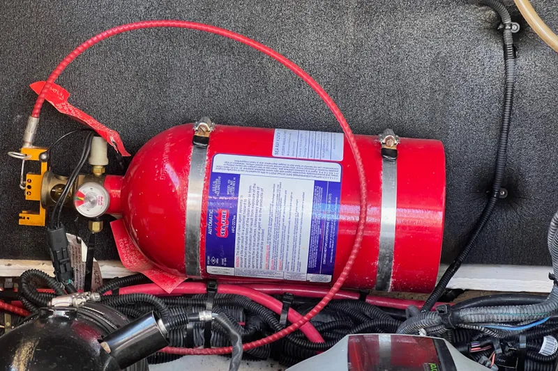Slide: The Image of Red fire extinguisher in a 2020 Sea Ray 280 SLX boat engine compartment. - 43
